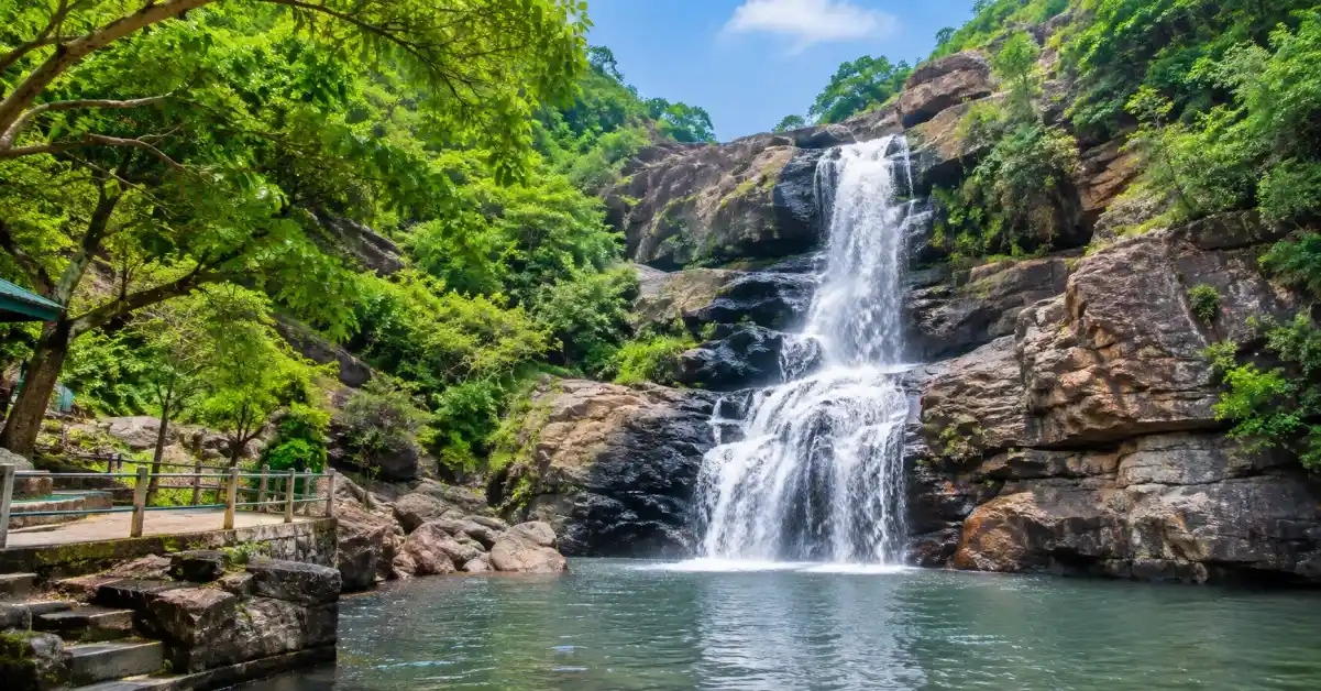 Talakona Waterfalls surrounded by green forests and rocky cliffs